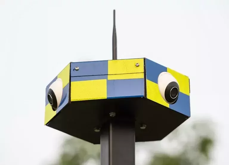 Close-up of the cameras on a yellow and blue Sitewatch CCTV tower